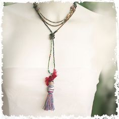 This versatile necklace can be worn with or without the stunning tassel pendant. Keep it long or wrap it around the neck or remove the pendant and wrap it around the wrist. The unusual pendant is made from my hand-rolled paper beads capped with a patinaed green Greek bead and wire-wrapped sari silk on top of that. It's a tribal-vibe look that complements the eclectic mix of beads in the long necklace. I made a silver swirled clasp to finish the look. The pendant slides off easily so that the necklace can also be worn as a wrap bracelet. ←→ LENGTH: 34" long, Tassel pendant adds about 4"   ❦ All my jewelry comes in a cute linen pouch or a pretty pillow box. If some of your items are gifts let me know and I will wrap them separately. ✦I am so glad you visited RocksandPaperSwans ... And thanks Bohemian Lariat Necklace As Gift, Spiritual Tassel Necklaces With Adjustable Fit, Bohemian Long Necklace With Tassels, Adjustable Bohemian Long Necklace With Tassels, Adjustable Spiritual Tassel Necklaces, Adjustable Elegant Tassel Necklace For Festival, Adjustable Spiritual Tassel Necklace For Festivals, Adjustable Multi-strand Hand Wrapped Necklaces, Bohemian Long Necklace With 108 Adjustable Beads