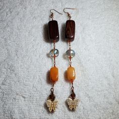 These Are Made With, - Wood Beads - Crystal Faceted Beads - Natural Orange Stone Beads - Wire Wrapped In Copper Wire And Copper Earhooks Handmade Beaded Brown Czech Glass Earrings, Brown Beaded Czech Glass Earrings, Brown Dangle Jewelry With Colorful Beads, Dangle Jewelry With Colorful Beads, Brown Faceted Beads Dangle Jewelry, Brown Dangle Beaded Earrings With Large Beads, Brown Large Beads Dangle Earrings, Brown Large Beaded Dangle Earrings, Peace Sign Bracelet