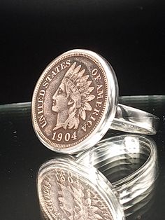 This Indian Head Penny ring is entirely hand built using thick, heavy gauge solid .925 sterling silver and .999 fine silver, made to order in your size for a perfect fit.  Each setting is hand built for each specific coin for the optimum fit and finish. The ring is meticulously hand polished to a mirror shine for a smooth, comfortable feel on the finger.  I use genuine vintage Indian Head pennies, grade good or better, locally sourced and hand selected. I bezel set the coin using traditional sil Silversmith Techniques, Penny Bracelet, Silver Coin Ring, Coin Rings, American Coins, Indian Head, Ring Mens, Rings Silver, Coin Ring