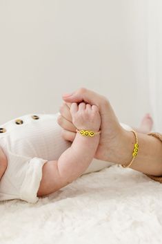 These sunny yellow smiley face beads surrounded by gold filled beads are a positive and darling accessory to highlight your child’s tiny wrist. The perfect accessory for every Mom + her mini! Made with the highest quality materials, this bracelet will look beautiful for years to come. Durable enough for play, precious enough to keep forever. Materials: 14k gold filled or sterling silver components. Nickel free. To learn more about our materials and what makes gold filled unique read here. Features: Each bracelet has a ½” extender chain to allow it to grow with your child. Guarantee: 100% satisfaction guaranteed. If you don’t love it, contact us to arrange a return/exchange. Read more about our quality guarantee here. PLEASE WATCH TEETHING BABIES CAREFULLY AS SMALL COMPONENTS CAN POSE AS A Cute Handmade Gold Beaded Bracelets, Personalized Cute Gold Beaded Bracelets, Cute Gold Beaded Bracelets For Mother's Day, Playful Gold Beaded Bracelets For Everyday, Hypoallergenic Gold Beaded Bracelets For Birthday, Cute Gold Beaded Bracelets For Birthday, Personalized Fun Gold Bracelets, Adjustable Playful Gold Jewelry, Playful Smiley Face Jewelry For Gifts