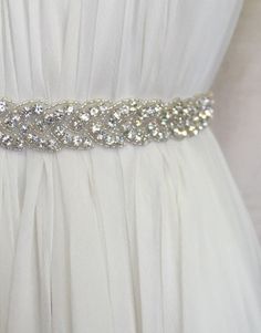 Bring the eye to your waist with this thin sparkly silver crystal beaded sash with a ribbon back closure. Vintage inspired sparkle finished with just a dollop of shine on each tail end. Customize wedding accessory with your choice of silk ribbon color. White Rehearsal Dress, Carol Hannah, Making A Wedding Dress, Wedding Braids, Veil Accessories, Rehearsal Dinner Dresses, Tea Length Wedding Dress, Belt Design, Luxury Wedding Dress