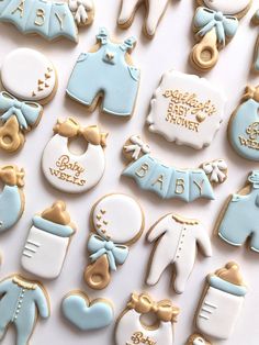 baby shower cookies arranged on top of each other with blue and gold decorations around them