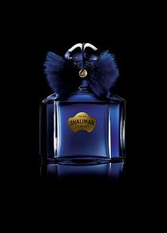 a bottle of shalimar perfume on a black background