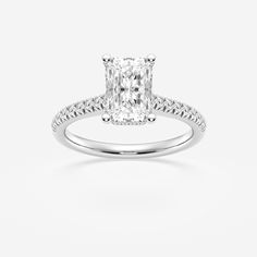 an engagement ring with a cushion cut diamond in the center and pave set shoulders