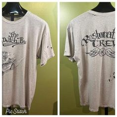 Vintage 1990's Von Dutch Bus T-shirt. Grey in color. Features a classic Von Dutch / Big Daddy Roth Monster driving "The Von Dutch Bus". Back says "Restoration Crew" witha flying Eyeball. In vintage shape, has some holes. Size X-Large. Measures 48" chest & 28" long. Gildan Ultra Cotton shirt. Vintage Logo Print T-shirt, Distressed Cotton Crew Neck Top, Casual Crew Neck Distressed Tops, Vintage Crew Neck Top With Sublimation Print, Vintage Sublimation Print Short Sleeve T-shirt, Vintage Short Sleeve Top With Sublimation Print, Vintage Crew Neck Shirt With Logo Print, Vintage Crew Neck Top With Logo Print, Vintage Graphic Print Crew Top