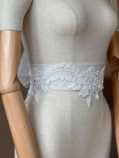 A stunning, elegant statement wedding sash is exquisitely beaded in beautiful vintage pattern. Your choice tulle  sash is attached to the beading and ties at the back into a bow. An ultimate luxurious accent piece for your wedding dress or for any special occasion dresses. Color ivory. Lace Bridal Belt With Lace Trim For Wedding, Lace Bridal Belt For Ceremony, White Fitted Lace Bridal Belt, Fitted White Lace Bridal Belt, White Bridal Belt For Bride, Fitted Lace Bridal Belt For Bride, Fitted Lace Bridal Belt For Ceremony, White Lace Bridal Belt For Ceremony, White Fitted Bridal Belt For Ceremony