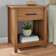 a small wooden table with a potted plant sitting on it's side shelf