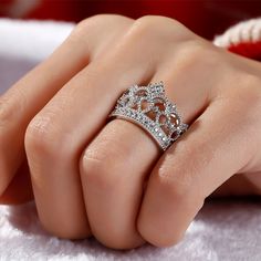 Delicate and romantic, this crown-shaped ring will utterly delight the queen of your heart. Fashioned in sleek sterling silver, this ring features open hearts and sparkling stones. Twinkling round stones, meaningful hearts and milgrain detailing complete this lovely style. A regal choice for your princess, this ring creates a romantic look. Carat Weight: 0.762 ctStone Size: 1.1,1.25,1.5 mmStone Type: Jeulia® StoneNumber of Stones: 31 Stone Color: Diamond WhiteStone Shape: RoundWeight: 5.63 gWidt Queen Crown Ring Design, Crown Ring Queen, Crown Design Rings In Cubic Zirconia, Luxury Crown Design Cubic Zirconia Rings, Elegant Crown Design Cubic Zirconia Rings, Elegant Rings With Crown Design, Luxury Cubic Zirconia Rings With Crown Design, Cubic Zirconia Diamond Ring With Crown Design, Elegant Cubic Zirconia Rings With Crown Design