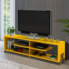 a yellow entertainment center with a flat screen tv mounted on it's sideboard