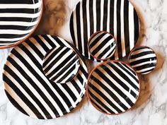 black and white striped plates on a marble table