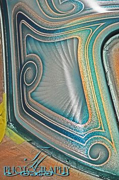 a close up view of the inside of an art glass window with swirls and curves