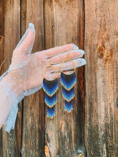 "🌊🌞 Dive into summertime with these stunning Blue Gold Ombre Beaded Fringe Earrings! These handwoven American style earrings are inspired by the vibrant colors of the ocean and make the perfect gift for any beach lover. Crafted from high-quality seed beads, these earrings feature a beautiful ombre design that fades from blue to gold, a symbol of the shining sun reflecting off the ocean.  These Blue Gold Ombre Beaded Fringe Earrings are perfect for adding a pop of color to any outfit. Their unique design will set you apart from any crowd. Whether you're heading to the beach or to a summer party, these earrings are the perfect accessory to complete your look. So why wait? Order your Blue Gold Ombre Beaded Fringe Earrings today and add a touch of ocean-inspired beauty to your style!🌊 🔎Siz Bead Jewelry Patterns, Blue Chandelier, Gold Ombre, Ombre Earrings, Beaded Fringe Earrings, Huichol Art, Ombre Design, Beach Lover, Beaded Jewelry Patterns