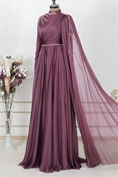 Step into elegance with this exquisite Full-Length Evening Gown. Crafted in a rich shade of deep plum, this gown features a luxurious chiffon fabric that drapes beautifully, creating a silhouette that flatters every figure. The delicate beading along the high neckline and waist adds a touch of sparkle, while the sweeping floor-length skirt ensures you make a grand entrance at any event.The intricate detailing on this gown sets it apart. A unique cross-body draping design adds depth and sophistic Pre-draped Georgette Wedding Dress, Pre-draped Floor-length Banquet Gown, Formal Georgette Dress With Sweep Train, Formal Chiffon Gown With Sweep Train, Evening Draped Georgette Gown, Draped Georgette Evening Gown, Purple Chiffon Evening Dress, Elegant Georgette Dress With Sweep Train, Elegant Chiffon Gown With Sweep Train