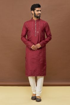 Maroon kurta with mirror work and mandarin collar. Paired with off white churidar.
Components: 2
Pattern: Embroidered
Type Of Work: Mirror
Neckline: Mandarin
Sleeve Type: Full
Fabric: Kurta: Dola Silk, Churidar: PV Cotton
Color: Maroon
Other Details: 
Mirror work
Occasion: Mehendi and Puja - Aza Fashions Designer Chanderi Kurta With Dabka Work, Semi-stitched Chanderi Sherwani With Mirror Work, Chanderi Sherwani With Dabka Work For Festivals, Chanderi Sherwani With Mirror Work, Unstitched Chanderi Kurta With Dabka Work, Festive Chanderi Kurta With Dabka Work, Festive Kurta With Mirror Work In Slub Silk, Designer Straight Kurta With Dabka Work, Festive Slub Silk Kurta With Mirror Work