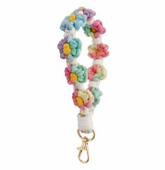 a white leash with multicolored crocheted flowers on the front and bottom