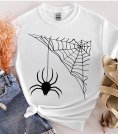 About this item Spider web t-shirt, Halloween shirt, customer t-shirt, Happy Halloween , designer shirt, desıgn gift, funny  special shirt, spooky season, Gildan unisex t-shirts We make design t-shirts, sweatshirts and hoodies that you can use at every special moment of your life and give as a gift to you and your loved ones... We are looking forward to adding color to your life... *  We use the Gildan Soft Style brand.  ---How To Order --- * Please, check and review all photos * Choose your t-s Halloween Graphic Print Top As Gift, Casual Halloween Tops For Gifts, Casual Halloween T-shirt For Gift, Short Sleeve Halloween Top As Gift, Halloween Spooky Sublimation Print T-shirt, Halloween Graphic Tee With Sublimation Print, Spooky Custom Print Halloween T-shirt, Halloween Crew Neck Shirt With Sublimation Print, White Halloween Shirt With Screen Print