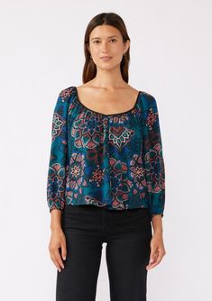 An ultra-relaxed fit bohemian blouse in a teal floral print. Floral Print Relaxed fit Hip-length Long raglan sleeves Elastic cuff Deep v-neckline in front and back Open back with tassel tie closure Contrast piping Bohemian fall blouse Dry clean only Embrace the essence of fall with our free and flowy bohemian blouse, designed for the modern muse. Featuring an effortlessly relaxed silhouette, billowy long sleeves, a wide v-neckline in the front and back, and a delicate tie back detail. Pair it wi Blouse Designed, Bohemian Blouse, Bohemian Fall, Fall Blouse, Modern Muse, Bohemian Blouses, Casual Night Out, Weekend Brunch, Contrast Piping