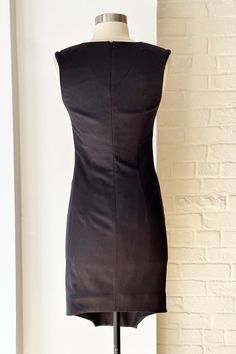 Contemporary charcoal wool dress with slightly padded structured shoulders and asymmetric hem with "scoop" details on the sides. Back zip closure. Lined. Fits size S / US 4 Excellent condition