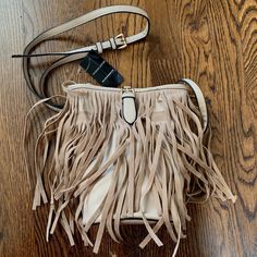 New With Tags Wilson’s Leather X Black Rivet Fringe Bucket Bag Color: Light Tan/Cream Gorgeous Bag With Gold Hardware And Adjustable Strap. Magnetic Buckle Clasp To Keep The Bag Closed. There Is One Tiny Imperfection From Storage (Pictured Below In 4th Photo Just Under Strap Not Noticeable). Trendy Beige Shoulder Bag With Fringe, Leather Fringe Bucket Bag For Everyday, Chic Beige Fringe Bag, Chic Beige Fringe Shoulder Bag, Beige Leather Bags With Fringe, Small Black Crossbody Bag, Chic Fringe Crossbody Shoulder Bag, Black Leather Fringe Bag, Boho Crossbody Bag