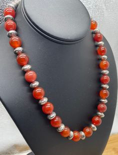 "Carnelian gemstone necklace with silk spaces.   Round 10mm beads 22\" long Carnelian Gemstone Healing  - Powerful healing stone that works on all Chakras to balance the mind, body, and spirit.  - Removes negative energy and allows positive to flow through." Silver Carnelian Beaded Necklace With Gemstone Beads, Spiritual Carnelian Round Bead Necklaces, Carnelian Round Bead Necklaces For Meditation, Carnelian Gemstone Beads Necklaces For Meditation, Spiritual Carnelian Round Beads Necklace, Silver Beaded Carnelian Necklaces, Silver Carnelian Beaded Necklace, Traditional Carnelian Gemstone Necklaces, Luxury Carnelian Gemstone Beads Necklace