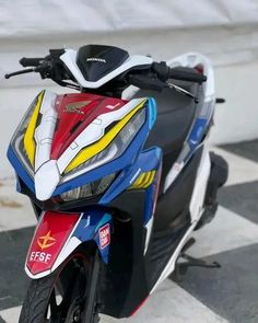 a motorcycle parked on top of a checkered floor