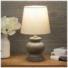 Base Dimensions: 5" W x 5" D Shade Dimensions: 7" H x 8" W x 8" D Full Height: 14.25" Cord Length: 60" Bulb Type: A 40W Power Source: Corded Electric Material: Resin, Fabric & Metal Color: Gray & Beige Quantity: 1 Illuminate your space with this Gray Rustic Table Lamp. This lamp's base has a rounded and curved shape with a dark gray, rustic finish. The beige lamp shade gives this piece a neutral look that will match a variety of decor styles. Place this lamp on a side table for a rustic addition Beige Lamp, Accent Desk, Beige Lamps, Electric Material, Resin Fabric, Rustic Table Lamps, Frame Light, Rustic Table, 7 H