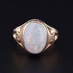 This antique ring (circa 1900) features a white opal set in 14k gold. The face of the ring measures 0.6 inches by 0.45 inches wide and is in good condition with some crazing to the opal.  The ring is a size 5.5, but it can be resized free of charge. We have many other fantastic offerings of period fine and costume jewelry posted on our Etsy store, so please consider browsing our other items. We send all items in individually packaged gift boxes. + Trademark Antiques Shop Homepage https://www.ets Classic Cabochon Opal Ring, Classic Cabochon Opal Ring For Formal Occasions, Classic Yellow Gold Opal Ring, Classic Opal Ring Collectible, Heirloom Opal Ring In 14k Gold, Classic Oval Opal Ring Collectible, Victorian 14k Gold Opal Ring For Anniversary, Victorian Style Hallmarked Opal Ring In Yellow Gold, Victorian Opal Ring In 14k Gold For Formal Occasions