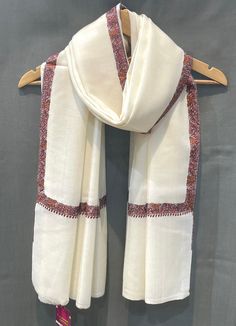 Kashmir is known for its craftsmanship. From carpets to shawls and scarves every single product made in Kashmir is made by diligent craftsmen who work round the clock to make a very fine quality product. This handmade shawl is made of 100% Pure Lamb Wool and its hand embroidered on the borders to give it a classical look. Its hand embroidered by traditional Kashmiri ways of needle embroidery The embroidery done on this is a traditional Kashmiri Embroidery known as ''Sozni Work''. Size: 41inch/81 Kashmiri Shawls Design, Scarf Painting, Kashmiri Embroidery, Embroidery Scarf, Embroidery Workshop, Kashmiri Shawls, Fabric Photography, Winter Wrap, Ancient Technology