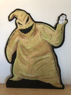 a cardboard cutout of a ghost holding a dice