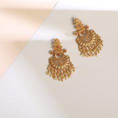 Description Inspired by the shimmering Indian gold jewelry. This Collection is designed to highlight fine Indian craftsmanship. It is crafted in gold-plated 925 silver with intricate textures and tones. Modern designs adorn you with timeless floral patterns. This jewelry is perfect for wedding and festival events. Glistening with festive elegance, these leafy floral silver chandbali earrings are a timeless piece made with traditional Indian design aesthetics. The design features a central floral Temple Jewelry Chandbali Bridal Earrings In Brass, Temple Jewelry Bridal Chandbali Earrings In Brass, Festive Wedding Chandbalis With Elegant Design, Brass Chandbali Danglers With Intricate Design, Traditional Brass Bridal Earrings With Intricate Design, Traditional Bridal Earrings With Intricate Design In Brass, Festive Bridal Chandbali Earrings With Elegant Design, Elegant Festive Brass Chandbalis, Bollywood Style Yellow Gold Chandbalis For Wedding