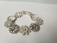 Vintage flowered bracelet silver tone bracelet antique jewelry. his is a lovely bracelet with silver & rhinestone flowered petals, unmarked. in good vintage condition. please all photos for details. thanks for looking and be sure to check out our other items! we have lots of vintage items, especially jewelry. we put new listings on daily so be sure to check back often. don't forget to add us to your favorites list! hughes-antique Adjustable Vintage Flower Shaped Jewelry, Silver Metal Crystal Bracelet Costume Jewelry Style, Vintage Silver Charm Bracelet For Wedding, Silver Crystal Bracelet For Formal Occasions, Silver Crystal Bracelet For Gift, Silver Crystal Bracelet Costume Jewelry For Gift, Silver Crystal Bracelet For Gift, Costume Jewelry Style, Adjustable Silver Crystal Bracelet For Costume Jewelry, Silver Costume Jewelry Crystal Bracelet Gift