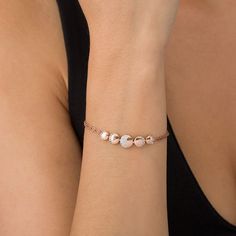 Set a whimsical tone with this romantic fashion bracelet. Crafted in sterling silver with 14K rose gold plate, this serene design showcases five graduated-size sculpted circles - each sparkling with petite shimmering white sapphires in crescent- and half-moon-shaped frames representing the lunar phases. Buffed to a brilliant luster, this 7.5-inch double-strand rope chain bracelet secures with a lobster claw clasp. Rose Gold Charm Bracelet With Jubilee Detail, Rose Gold Charm Bracelet With Jubilee Bracelet, Rose Gold Bracelets For Anniversary In Fine Jewelry Style, Elegant Rose Gold Sterling Silver Jubilee Bracelet, Rose Gold Jubilee Charm Bracelet, Rose Gold Sterling Silver Charm Bracelet For Anniversary, Adjustable Rose Gold Sterling Silver Chain Bracelet, Adjustable Sterling Silver Chain Bracelet In Rose Gold, Rose Gold Sterling Silver Chain Bracelet