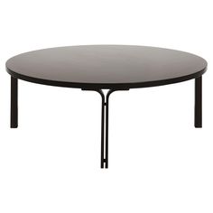 a round table with black metal legs on a white background, viewed from the front