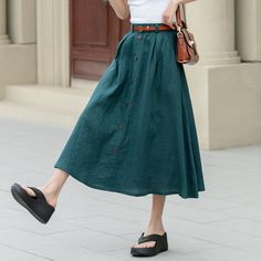 "Showcase your style in a sophisticated mid-calf A-line skirt, beautifully tailored in a lush shade of green. The skirt features a distinctive button detail that adds a unique touch. Ideal for the blooming season of spring, this skirt is a perfect addition to any plus size wardrobe.  DETAIL * 100% Linen * Two side pockets * Back elastic waist * Button front skirt * Below Knee Length * Midi skirt  * A Line skirt * Perfect for Spring, Summer and Autumn * Wash by hand or machine with cold water * Model's belt is not sale item More colors :  https://etsy.me/3PlsCmO * The model is 170 cm (5′ 7″) tall with a 80 cm (31.5\") bust, 66 cm (26\") waist. She is wearing in size XS. CUSTOM MADE SERVICE If you * Change other color * Can't find your size in our size Chart * Change the Style * Change the l Long Cotton Skirt With Buttons, Casual Maxi Skirt With Button Closure For Summer, Casual Long Skirt With Buttons, Casual Full Skirt With Button Closure, Cotton Full Skirt With Buttons, Casual Full Skirt Bottoms With Button Closure, Relaxed Full Skirt With Buttons, Casual Relaxed Maxi Skirt With Button Closure, Knee-length Cotton Skirt With Buttons