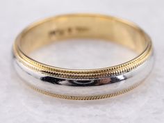 two tone gold and silver wedding band on white background, close - up shot with shallow focus