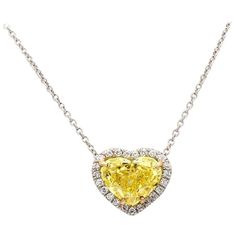 For sale is a lady's platinum and 18K yellow gold 2.12ct Fancy Vivid Yellow GIA Certified Heart shaped diamond necklace accented with 0.11 carats of round diamonds. CENTER STONE: 2.12ct FYV SI1 Heart Shaped Diamond ACCENT/SIDE STONES: 23 Round Brilliant Cut Diamonds (approx. 0.11ctw) METAL: Platinum, 18K Yellow Gold GRAMS: 1.4 SIZE: 16" LAB REPORT: GIA #2135870063 REFERENCE NUMBER: NK2795/FCX0022 Fancy Yellow Diamond Necklace, Luxury Yellow Gold Diamond Heart Necklace, Yellow Heart Cut Fine Jewelry, Gia Certified Fine Heart Shaped Jewelry, Gia Certified Heart-shaped Fine Jewelry, Fine Jewelry Gia Certified Heart-shaped, Fine Jewelry Heart-shaped Gia Certified, Yellow Platinum Fine Jewelry, Gia Certified Yellow Gold Diamond Necklace