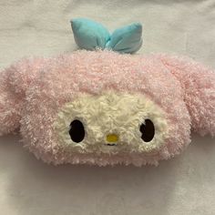 a close up of a stuffed animal with a bow on it's head and eyes