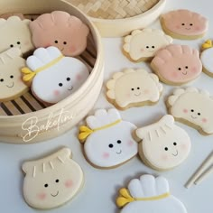 decorated cookies in the shape of baby's head and other items on a table