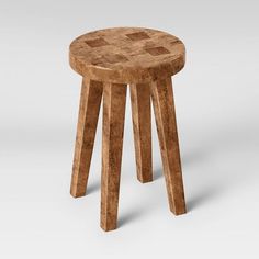 a small stool made out of wood with an unusual design on the top and bottom