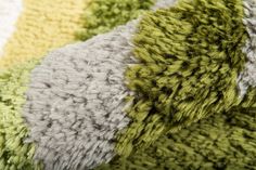 several different colored rugs are stacked together on top of each other in this close up photo