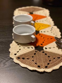 crocheted placemats with coffee cups on them