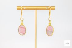 Behold these lovely gold-leafed pink Peruvian opal drop earrings! They exude understated elegance and add a modern feminine touch to your look. They are easily dressed up or down, and are perfect for any occasion. Beautiful, smooth, gold-leafed pink Peruvian opal bezels. These beautiful stones have natural patterns in shades for pink, grey, white, dusty rose pink coral pink, black and white. Gold-plated lever backs for a secure and comfortable fit. 1.75 inches longThese unique and beautiful earrings are perfect for a special gift or addition to your own collection! Due to natural variations in the gemstones your purchased item may not be identical to the one pictured. There may be natural but slight asymmetries (small differences) and imperfections in the size, shapes, colors, and patterns Elegant Gold Jewelry With Pink Opal, Elegant Pink Opal Jewelry For Formal Occasions, Elegant Formal Pink Opal Jewelry, Elegant Pink Opal Jewelry Gift, Elegant Pink Opal Jewelry For Gift, Opal Earrings With Ear Wire For Gift, Elegant Pink Opal Oval Jewelry, Handmade Elegant Pink Opal Jewelry, Opal Ear Wire Earrings For Gift