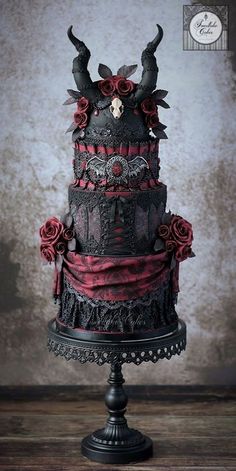 a three tiered cake decorated with skulls and roses