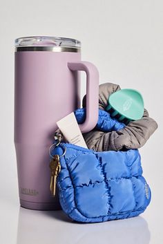 a purple cup with a blue bag next to it