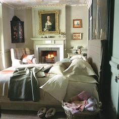 a bedroom with a fireplace and pictures on the wall