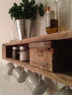 a wooden shelf with cups and jars on it