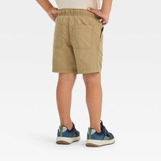 Get your little one ready to kick back, run and play in cute style with these Woven Solid Pull-On Shorts from Cat & Jack™. The mid-rise shorts are made from 100% cotton to keep your child in breathable all-day comfort, and the solid-color finish allows easy pairing with a variety of tops. The full elastic waistband with a front drawstring lets them find a secure fit, while the side and back pockets provide space for their tiny essentials. Cat & Jack™: Kids’ clothing with an imagination of its ow Mid Rise Shorts, Cute Style, Fabric Tape, Pair Of Pants, Cat & Jack, Body Measurements, Kids Clothing, Toddler Boys, Shoe Laces