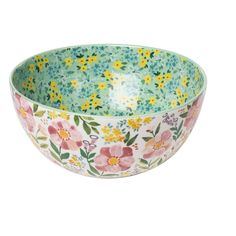 a large bowl with flowers painted on the side and green, yellow and pink colors