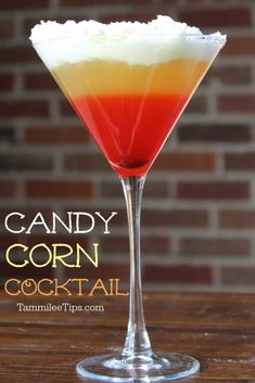 the candy corn cocktail is garnished with whipped cream