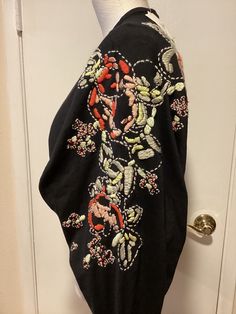 This lovely shrug/cardigan has beautiful embroidery  as shown in the photos. Long raglan type sleeves Open front  55% Silk / 45% Cotton This was purchased several years ago, however,  it is new with tags and has never been worn All my items were purchased from a major department store. All my items come from a pet and smoke free home. Payment is due within 1 day of the auction's end. Thanks! If I have only one shipping option shown, I can always add another one for your convenience (such as USPS Ground Advantage.) Just let me know. Thank you. Embroidered Crew Neck Cardigan For Fall, Winter Floral Embroidered Crew Neck Cardigan, Winter Crew Neck Cardigan With Floral Embroidery, Winter Floral Embroidery Crew Neck Cardigan, Winter Cardigan With Floral Embroidery And Crew Neck, Black Long Sleeve Sweater With Floral Embroidery, Black Embroidered Long Sleeve Cardigan, Fitted Embroidered Crew Neck Cardigan, Fitted Crew Neck Embroidered Cardigan